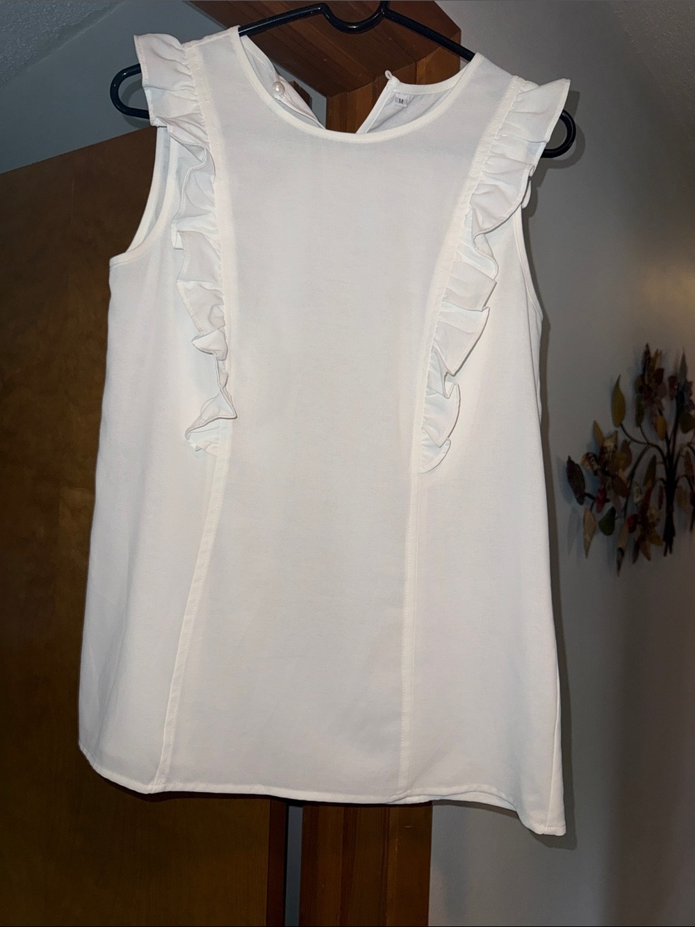 Cream colored sleeveless blouse